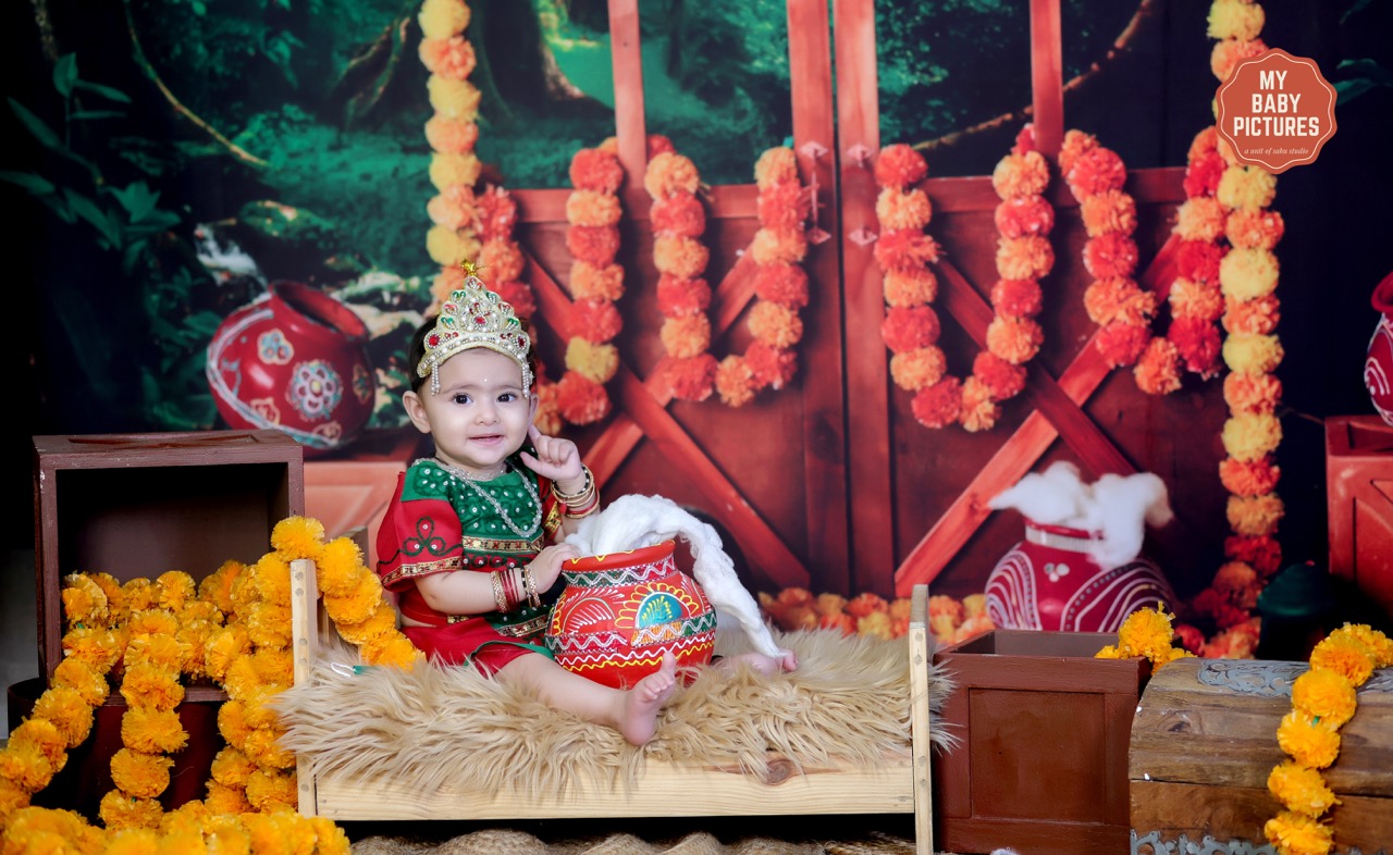 Baby girl dressed as Radha with a pot of butter in a Vrindavan photoshoot